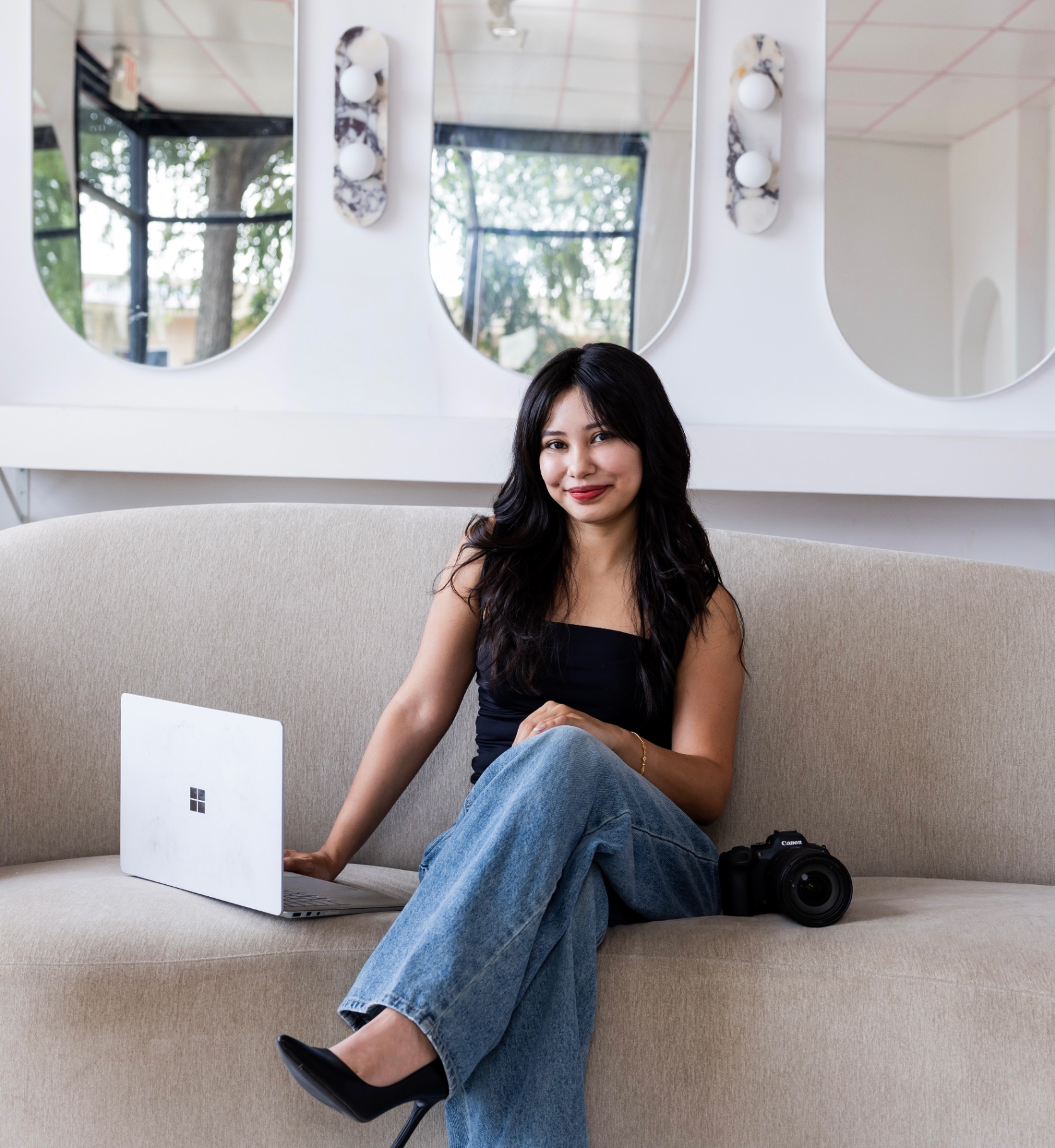 Portrait of the studio's founder, seated with a laptop